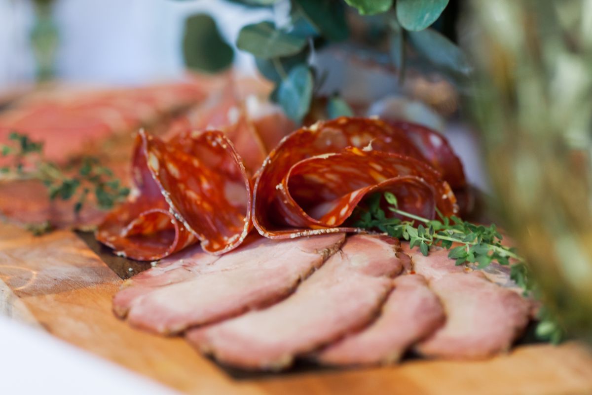 Sliced deli meats on a wooden board
