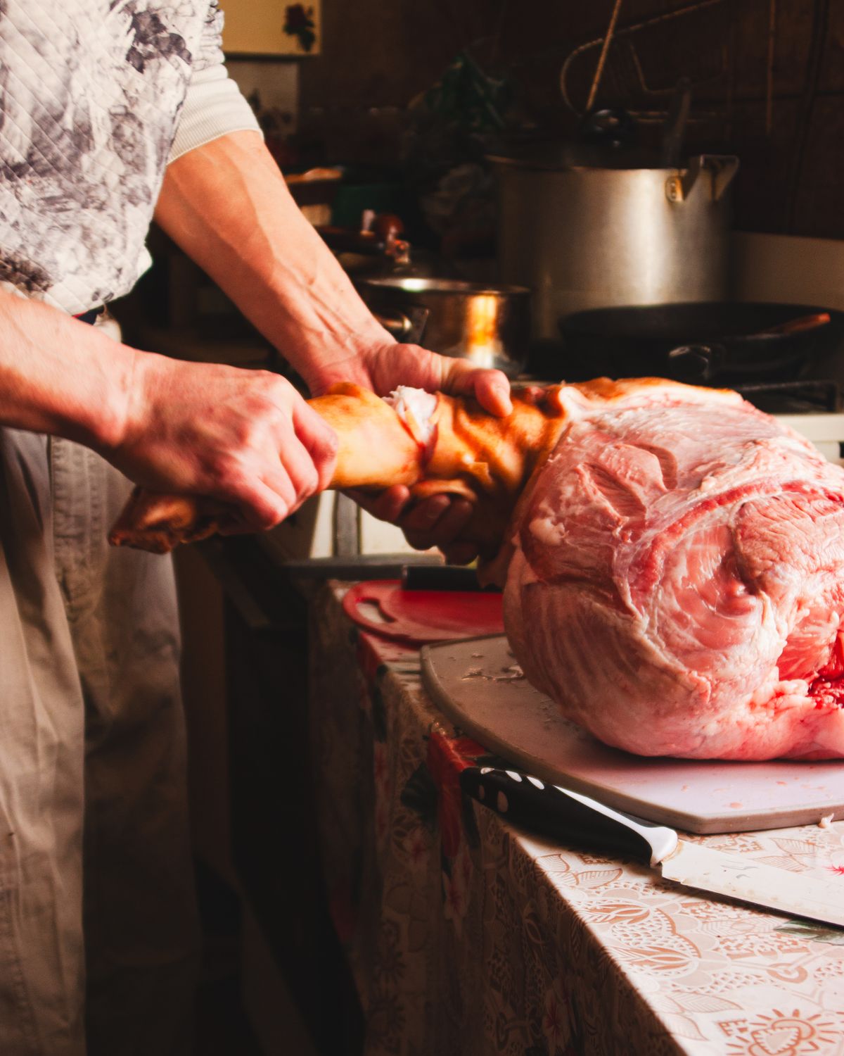 Butcher cutting a large piece of meat